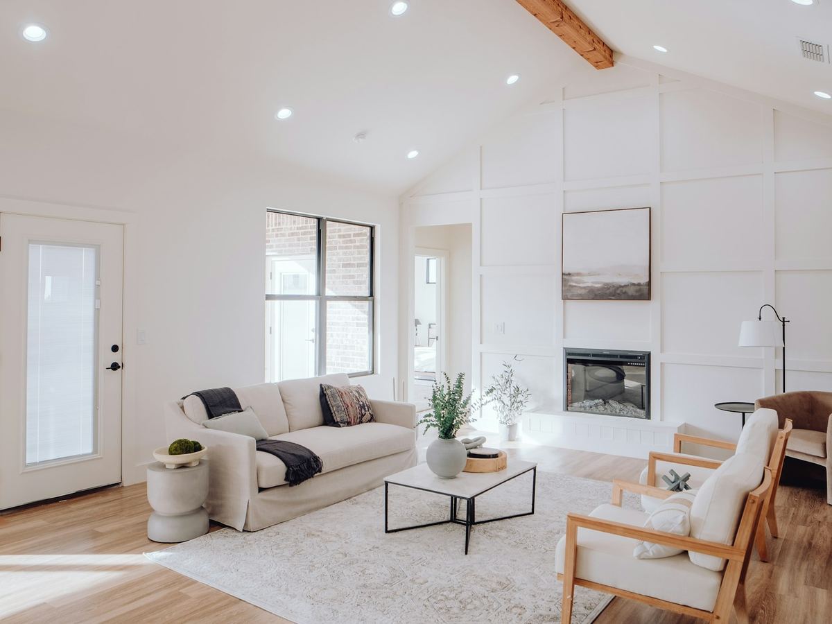 A bright, clean living room with a large area rug